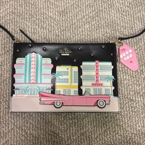 Kate Spade New York Checking In Car pink Cadillac Crossbody Clutch bag in black